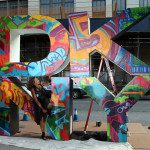 Donna Karen in front of DKNY Sign