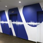 WMG Logo with Sound Waves across Elevators